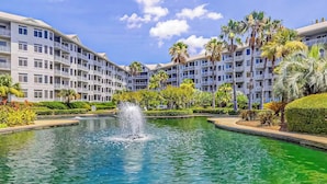 A hotel with a central fountain, surrounded by lush greenery and palm trees. - Sea Crest 2509 - Beautiful 5th Floor Condo with Breathtaking Ocean Views! (Hilton Head Island)