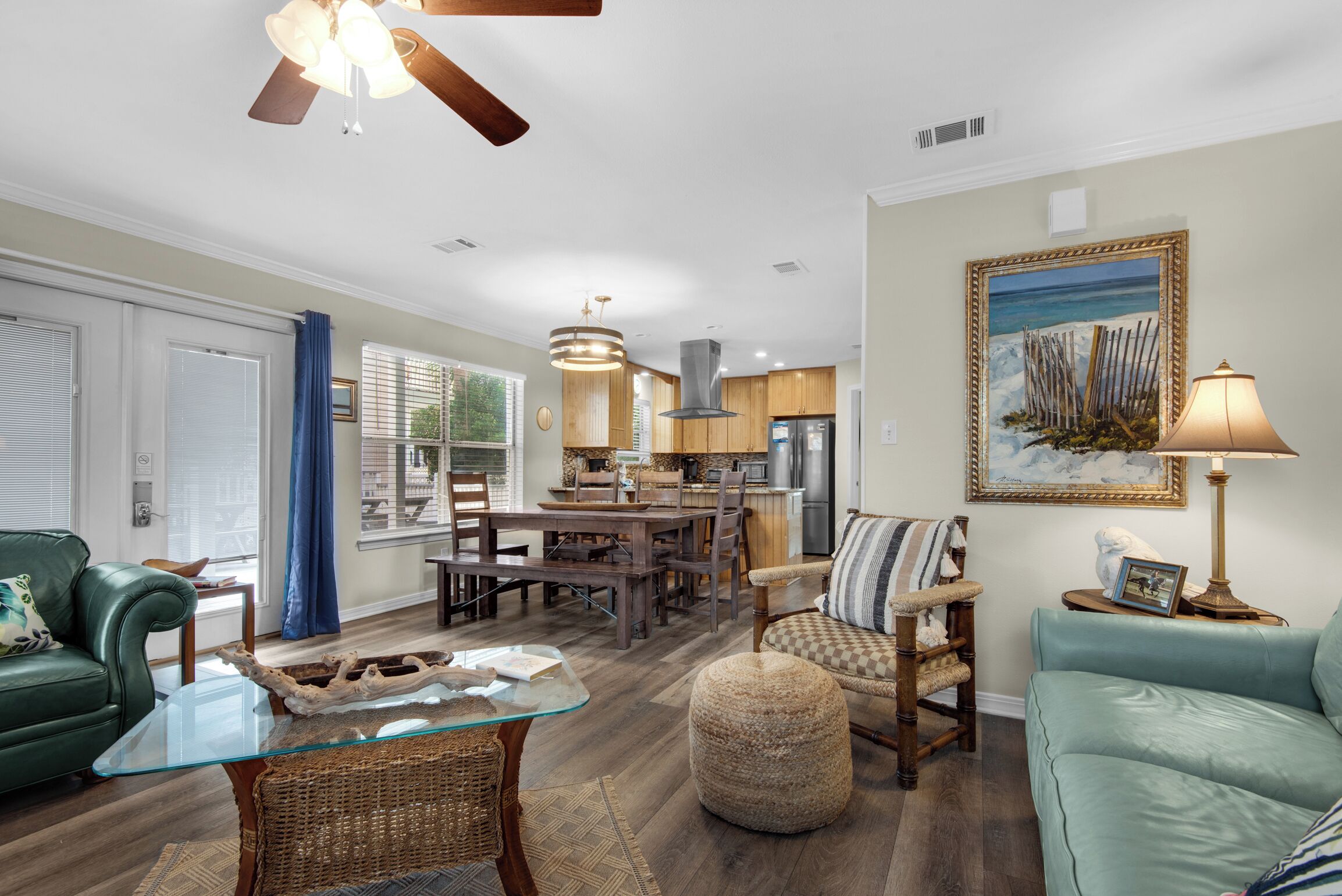 A spacious living area with a dining table, a sofa, and a coffee table.