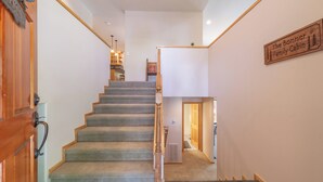 A staircase leading to a family cabin area with a wooden sign indicating the location. - Luxury Family Home, Hot Tub, Garage, Family Room, Near Tahoe City in Carnelian Bay (Carnelian Bay)