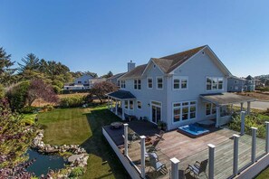 A large two-story house with a deck, a hot tub, and a landscaped yard. - Garden Pond Retreat~Hot tub & Fire Pit! (Mckinleyville)