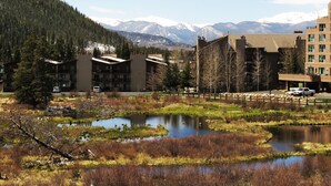 A hotel with a modern architectural design, featuring multiple floors and a flat roof. - On River Trail! 2 Hot Tubs. Walk to Festivals, Dining, Shops, Activities (Keystone)