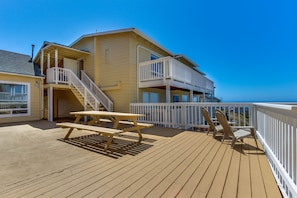 Enjoy ocean views from the upper-level balcony with a picnic table and two chairs on the deck.