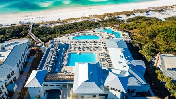 A resort with multiple swimming pools, a beach, and lush greenery. - The WaterColor Escape You've Been Dreaming Of – Remodeled Kitchen/Golf Cart (Santa Rosa Beach)