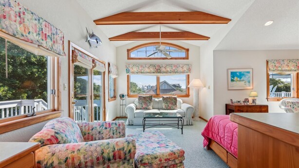 A cozy room with a wooden ceiling, a sofa set, a bed, and a desk. - ONLY 370 feet to beach access! HUGE LOADED home! Private Pool, Hot Tub, Game room with Pool Table! (Southern Shores)