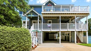A two-story building with a balcony and a covered entrance. - ONLY 370 feet to beach access! HUGE LOADED home! Private Pool, Hot Tub, Game room with Pool Table! (Southern Shores)