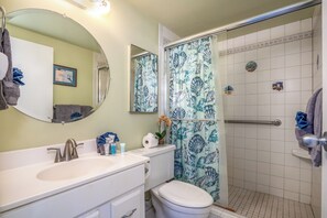 A bathroom with a sink, toilet, and shower.
