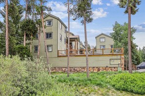 A two-story building with a balcony, surrounded by trees. - Atrium 108: Historic District Ski Condo, Fireplace, Hot Tub Access. (Breckenridge)