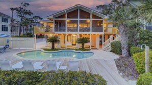 A two-story house with a swimming pool, outdoor seating, and a 'No Diving' sign.