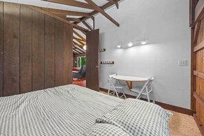 A bedroom with a bed, a desk, and a chair. - Great Adventure: Family Fun Starts Here! (Keuka Park)