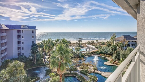 A resort with multiple swimming pools, a beach, and ocean views.