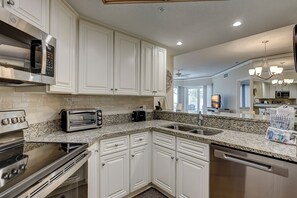 Enjoy cooking in this well-equipped kitchen with a stove, oven, and dishwasher.