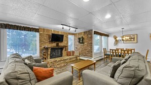 A living room with a fireplace, television, and comfortable seating. - Free SkyCard Activities - Budget, Walk to Town, Pool & Hot Tubs - The Lift C112 (Breckenridge)