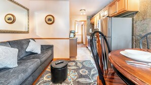 A compact living space with a sofa, a dining table, and a kitchen area. - Top Floor Unit with Many Upgrades! Ski In, Walk Everywhere! | PM6A (Breckenridge)