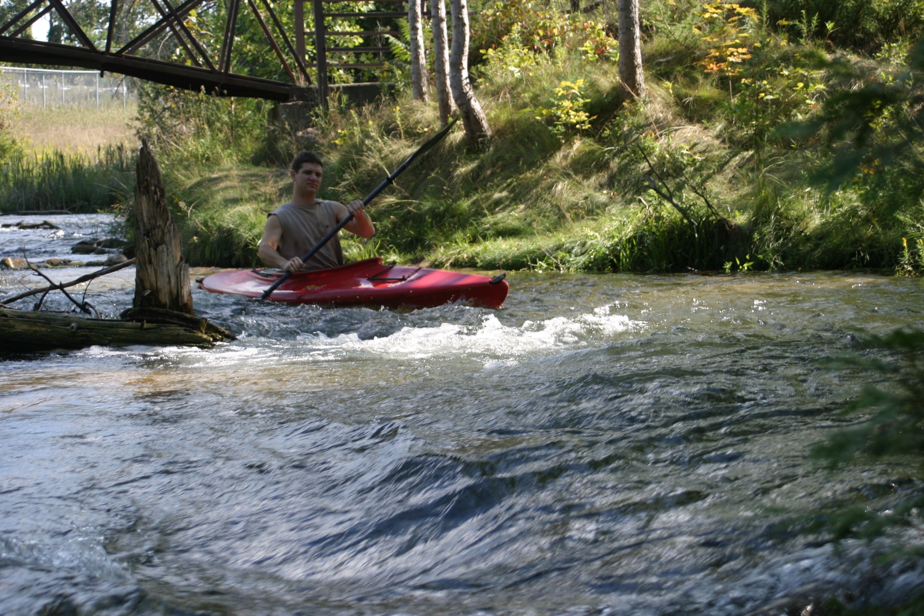 A person kayaking on a river.