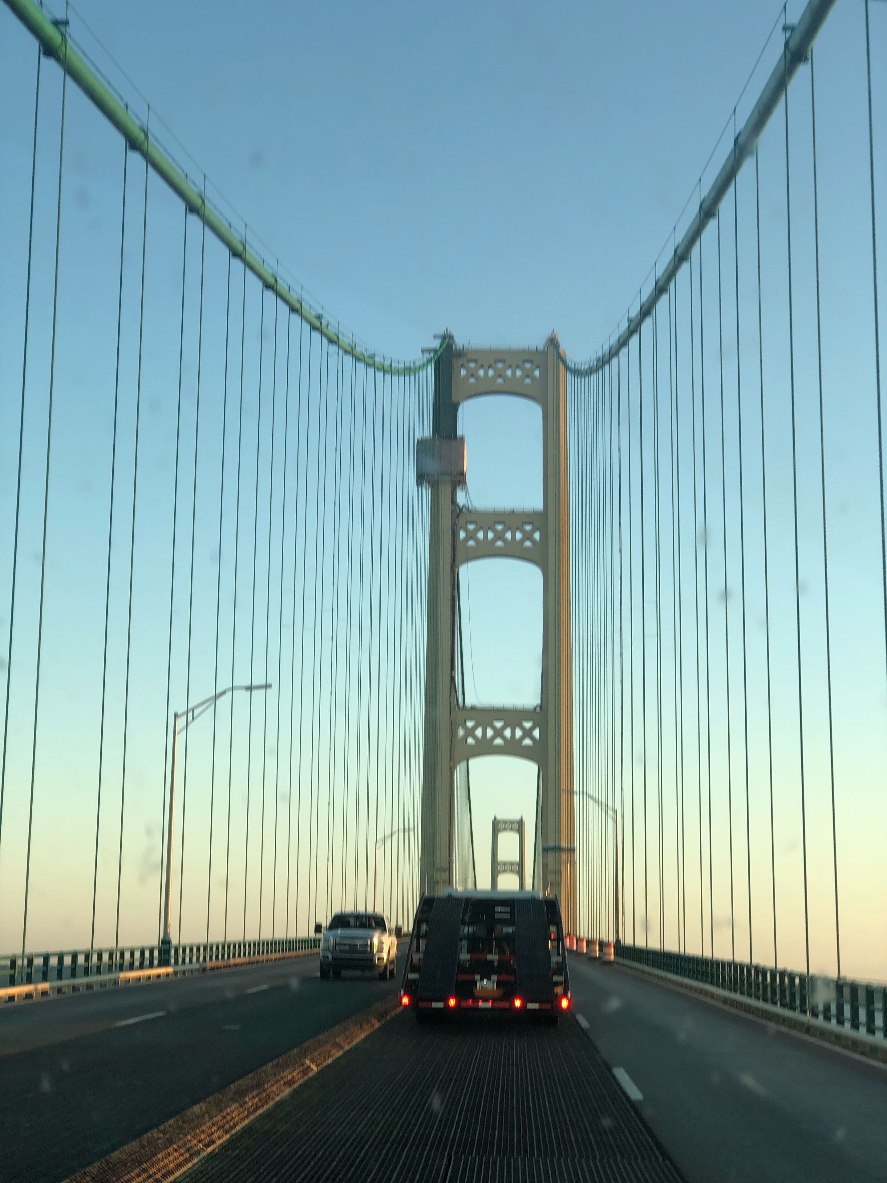 A bridge with a central tower and suspension cables.