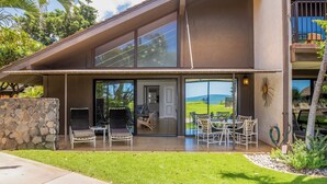 A modern house with a patio, outdoor seating, and a view of the landscape. - Ma'alaea Surf Unit C1 Beachfront Condo, 2BR Ground Floor, AC, Wifi, Kitchen (Kihei)
