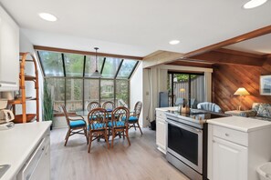 Enjoy meals in the kitchen with a central island and dining area, offering a clear view of the outdoor space.
