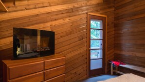 A wooden cabin room with a bed, a dresser, and a window. - Summer special, stay before 9/8/26 get third night free ! (Government Camp)