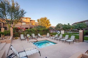 A pool area with lounge chairs, a pool, and a gated entrance. - Cowboy House Luxurious 3 bedroom Condo/ CommunityPool/ Grayhawk/ Scottsdale (Scottsdale)