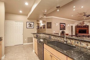 A kitchen with a granite countertop, a sink, and a ceiling fan. - Cowboy House Luxurious 3 bedroom Condo/ CommunityPool/ Grayhawk/ Scottsdale (Scottsdale)