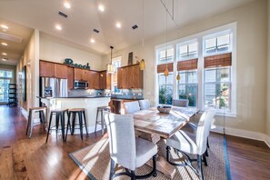 A spacious kitchen with wooden cabinets, stainless steel appliances, and a large island.