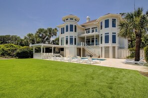 A large, two-story house with a covered patio, a swimming pool, and a well-maintained lawn. - 10 Curlew OCEANFRONT, 5 Bedroom w/ Private Heated Pool, Spa & Outdoor Kitchen (Hilton Head Island)