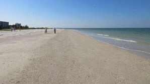 A wide sandy beach with a clear blue sky. - Beachfront Condo Offers Fun and Sun At Bargain Price! PET FRIENDLY! (Fort Myers Beach)