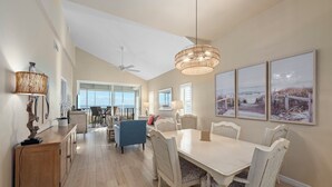 A spacious dining area with a high ceiling and a view of the outdoors. - Beachfront Bliss at Shell Island Beach Club 5D (Sanibel Island)