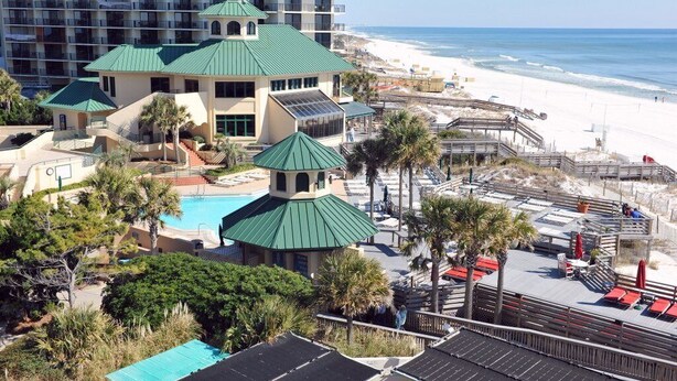 A resort with multiple buildings, a swimming pool, and a beach view. - Golf Cart! Pet-friendly! Linkside Village 435! (Miramar Beach)