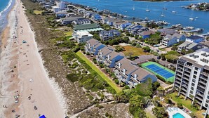 A coastal resort with a beach, marina, and several buildings with balconies. - Beautiful ocean front townhome in the heart of WB! (Wrightsville Beach)