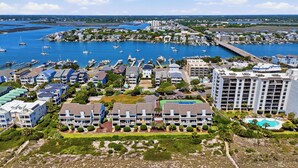 A coastal hotel with multiple buildings, a marina with boats, and a beach. - Beautiful ocean front townhome in the heart of WB! (Wrightsville Beach)