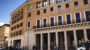 A multi-story building with a classical architectural style, featuring a central entrance with columns, large windows, and balconies. - Navona Living Rome (Rome)