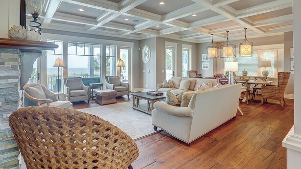 A spacious living room with a fireplace, comfortable seating, and a view of the outdoors.