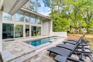 A modern house with a swimming pool, outdoor seating, and a garden. - 4 Merganser Court -Dog-Friendly, Private Pool, & Quick Walk to Beach/Marina (Hilton Head Island)