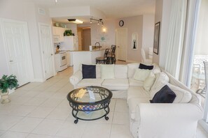 Relax in this open-plan living space featuring a central seating area and dining nook.