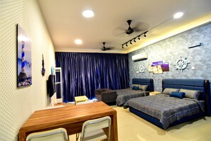 A bedroom with two beds, a desk, chairs, a ceiling fan, and decorative wall art. - Palazio Sailing Themed Holiday Homestay (Johor Bahru)