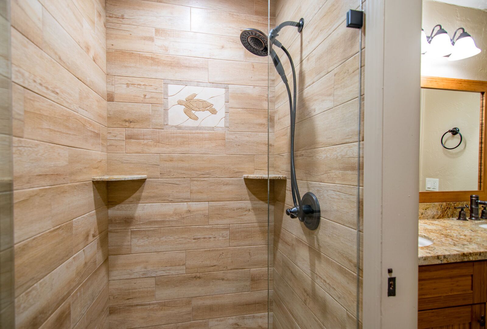 A shower with a wooden wall design, a towel rack, and a tiled artwork.