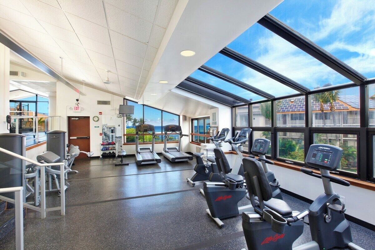 A gym with treadmills, elliptical machines, and weight machines.