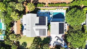 A residential property with a swimming pool, solar panels, and a well-maintained garden.