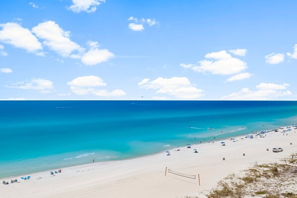 Relax on the beach with umbrellas and sun loungers, enjoy volleyball and soak up the sun.