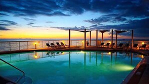 A pool with lounge chairs and a sunset view. - BEACHFRONT CONDO! 8TH FLOOR! FREE BEACH SERVICE (Panama City Beach)