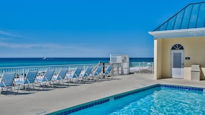 A pool area with lounge chairs and a view of the ocean. - 🌴Beach Chairs~Gulf Views~2 Pools~Leeward Key 905~Suite Sea-Cret🌴 (Miramar Beach)
