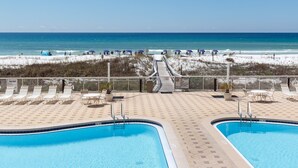 A pool area with two pools, a beach view, and a pathway leading to the beach. - Summer Place #204 - 3 BR Beachfront Condo - Free Beach Service! (Fort Walton Beach)