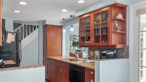 A kitchen with wooden cabinets, a dishwasher, and a stove.