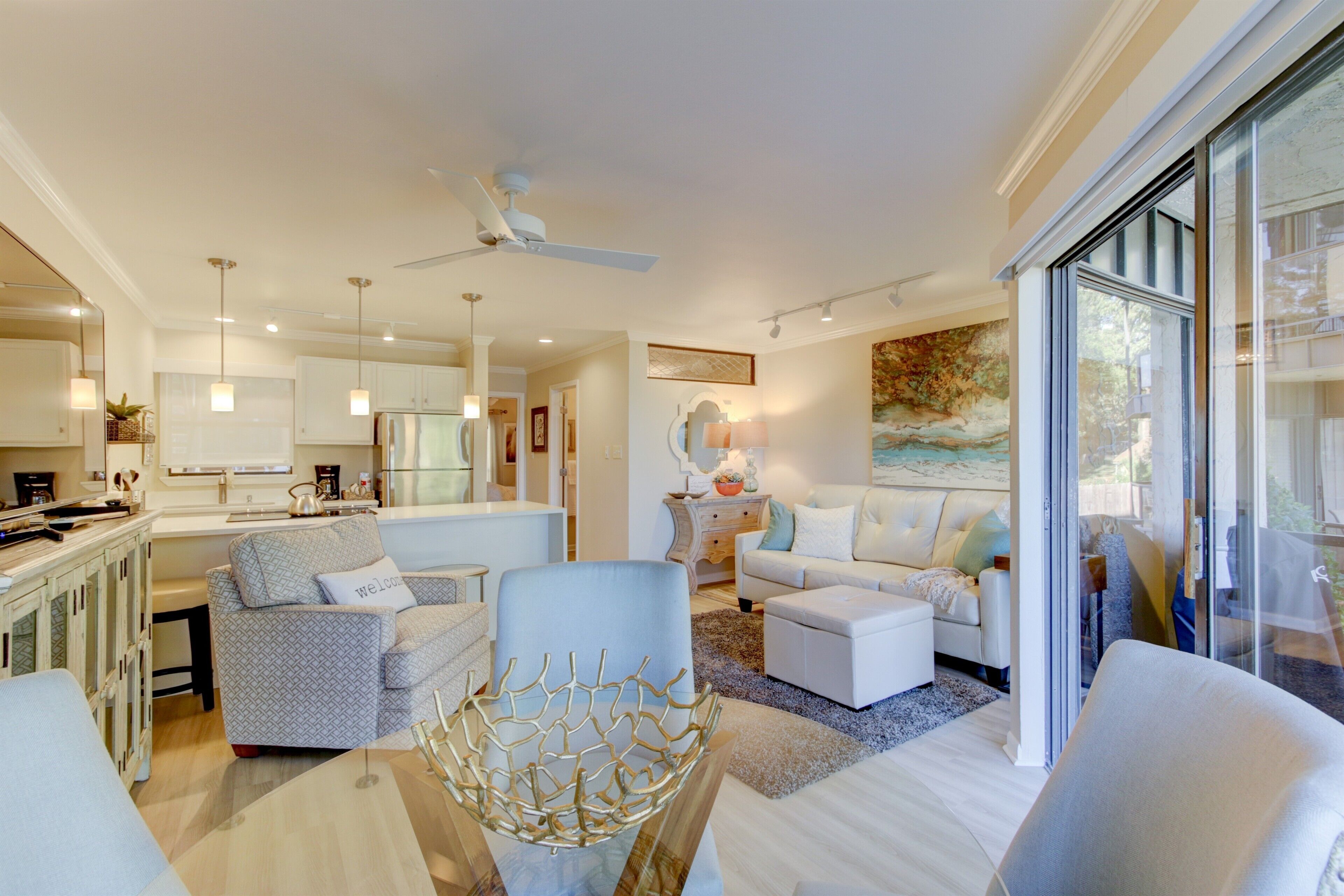 A spacious living area with a modern kitchen, a dining area, and a large window providing natural light.