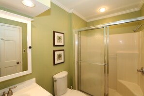 A bathroom with a toilet, sink, and shower.