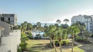 A resort with a pool, palm trees, and a view of the ocean. - Shorewood 332 - Oceanview 3rd Floor Condo (Hilton Head Island)