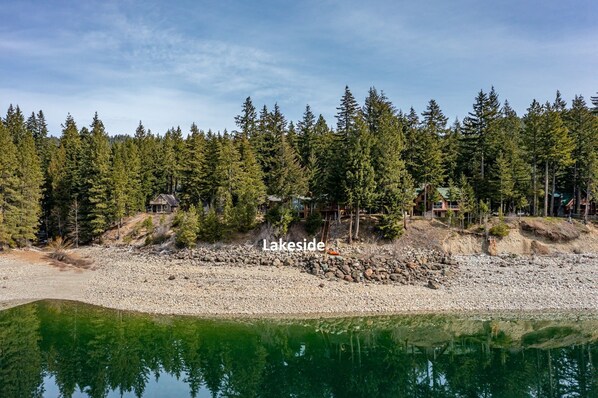 A lakeside property with a clear view of the lake, surrounded by dense forest and multiple cabins. - Lakefront Mt Retreat | Peaceful Views, Spa/GameRm + Arrive & Leave at 1PM (Ronald)