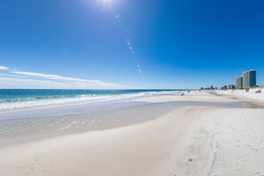 A beach with clear skies and calm waters. - Phoenix VII 1206 | Heated Pool | Tennis | My Beach Getaways (Orange Beach)