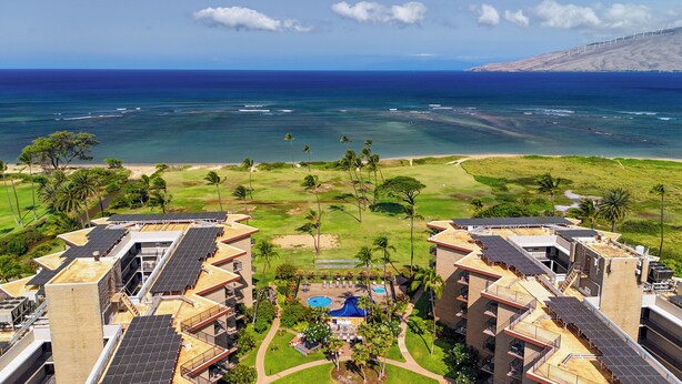 A resort with multiple buildings, a swimming pool, and a view of the ocean. - Kauhale Makai #330 Oceanfront, Pool, Hot tub, A/C, Wi-Fi, Stunning Sunsets! (Kihei)